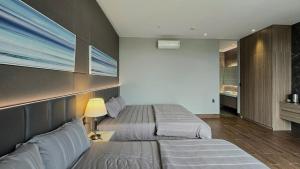 a hotel room with two beds and a lamp at Villa Phong Thuỷ in Xóm Tram +3 photos