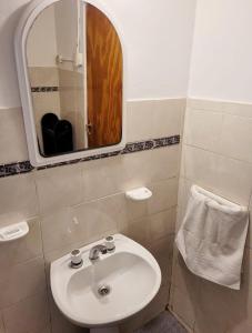 a bathroom with a sink and a mirror at El Canto de la Ballena Loft 1 in Puerto Pirámides