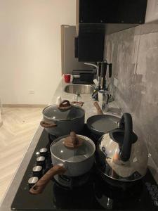 a kitchen with three pots and pans on a counter at Moderno Apto Estudio 02 in Cajamarca +9 photos