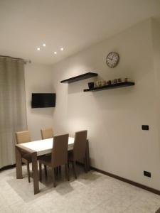 a dining room with a table and chairs and a clock at Ca' Novo in Venice