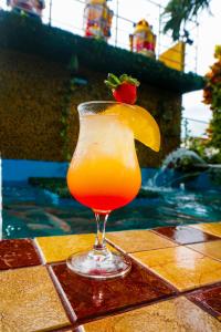 a drink sitting on a table next to a swimming pool at Hotel Casa Miller in Panama City +33 photos
