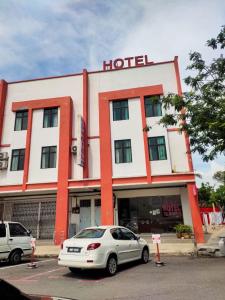 a white car parked in front of a hotel at S&P Hotel in Tampin +7 photos