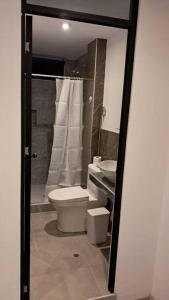 a bathroom with a toilet and a sink at Estreno Apto Estudio 04 in Cajamarca +26 photos