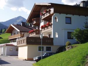a building with flower boxes on the balconies on it at Haus Dristner in Tux