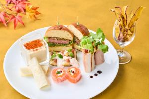 a plate of food with a sandwich and other foods at Hotel Kanazawa in Kanazawa