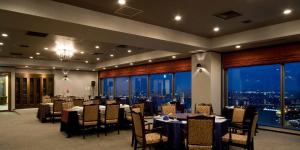 a conference room with tables and chairs and a view of the city at Hotel Kanazawa in Kanazawa +37 photos
