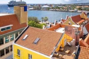 una vista aérea de un edificio amarillo junto al agua en Apartamento en Willemstad Curazao, en Willemstad