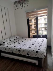 a bedroom with a bed in a room with a window at DMCI Bristle Ridge Condo 318 Cozy 2 Bedroom Unit in Baguio