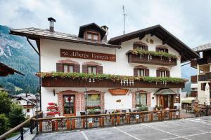 a building with flowers on the side of it at Albergo Venezia in Sappada