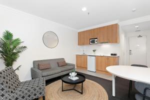 a living room with a couch and a table at Perth's Premie King Deluxe in Perth +9 photos