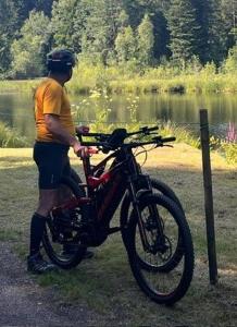 a man is standing next to a motorcycle at gite du Breuchin in La Longine