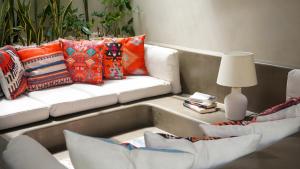 a living room with a couch and a table with a lamp at El Salao Villas in El Nido