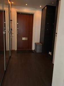 a hallway with a wooden door in a building at Close2City in Nacka