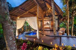 an outdoor deck with a hot tub in a villa at Chenshock Homestay in Mon