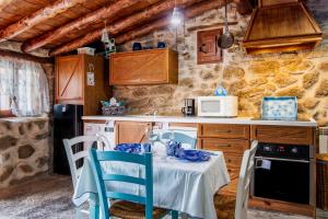 a kitchen with a table and chairs in a room at La Cuadra in Villar de Corneja