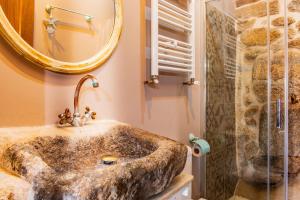 a bathroom with a sink and a shower at La Cuadra in Villar de Corneja +20 photos