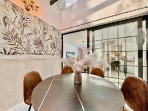 a dining room with a table and chairs at Domenico Morani Luxury Villa Concept with private pool by DadoVillas in Gastourion