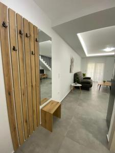 a living room with wooden lockers and a couch at Margarita's apartment 4 in Nea Peramos