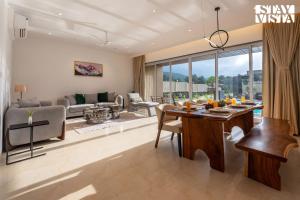 a living room with a table and a couch at StayVista at Gulposh Retreat with Pool, Lawn & Gazebo in Karjat