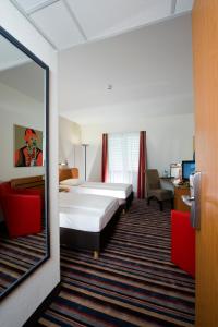 Cama o camas de una habitación en H+ Hotel Leipzig