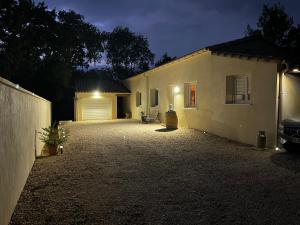 a house with a car parked in front of it at Villa Simone proche Uzes et pont du Gard in Blauzac