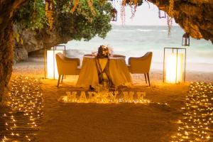 a table on the beach with candles and lights at Fairways and Bluewater Boracay in Boracay