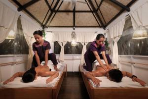 a group of people laying on beds in a room at Villa Khadine Grand Vista Resort in Coron