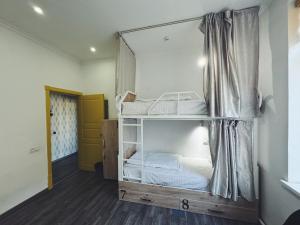 a bedroom with a bunk bed in a room at Registan Hostel in Samarkand