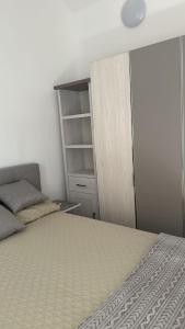 a small bedroom with a bed and a closet at Two Rooms Apartment near S8 line in Munich