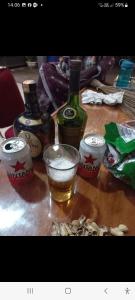 a table with two bottles and a glass of alcohol at WISMA SUNRISE GUEST HOUSE 10 minutes by walking to the big fruit market in Berastagi in Berastagi