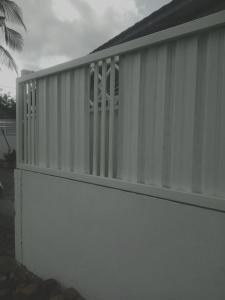 a white wall with a window on top of it at Rumah Putih Edi in Sengkol