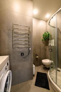 a bathroom with a shower and a toilet and a sink at Liepaja Apartments Parkside in Liepāja +40 photos