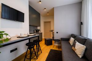 a living room with a couch and a table at Liepaja Apartments Parkside in Liepāja
