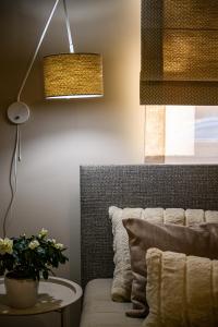 a living room with a couch and a table and a lamp at Liepaja Apartments Parkside in Liepāja