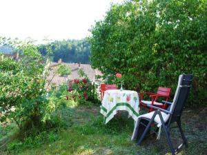 a table and four chairs in a garden at Haus Am Bühl in Schönau im Schwarzwald