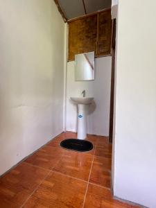 a bathroom with a sink in the corner of a room at Nong Khiaw Ing Ing Mountain View in Nongkhiaw