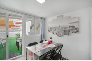 a dining room with a table and a window at Villa Monica in Agüimes