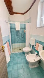 a bathroom with a shower and a toilet and a sink at Onda Marina Apartments in Forio d'Ischia +45 photos