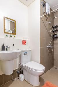 a bathroom with a toilet and a sink and a shower at Perfect accommodation for you in Levels Burbank in Manila