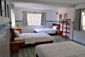 a hotel room with two beds and a window at Dary's Village Guesthouse & Restaurant in Phumĭ Chŏng Kaôh