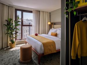 a hotel room with a bed and a window at Max Brown Hotel 5th District, part of Sircle Collection in Vienna