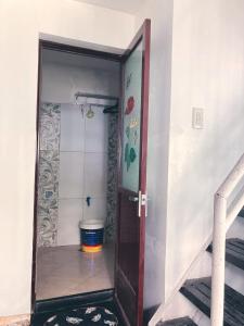 a bathroom with a shower and a toilet in a room at Aliyah Transient House in Atimonan +82 photos