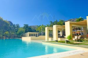 a large swimming pool in front of a resort at PICO DE LORO Pool Accessible CAROLA 2 Bedroom Units by SEE Condominiums in Nasugbu