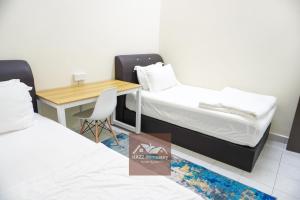 a room with a desk and a bed and a table at HAZZ Homestay Kulim in Kulim