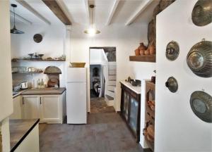 a large kitchen with white walls and a counter at Skyros BnB ANNA House in Brooke in Skiros +16 photos