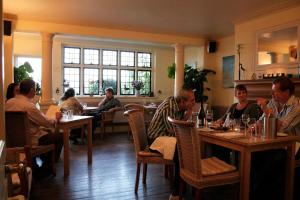 a group of people sitting at tables in a restaurant at Haydens in Rye