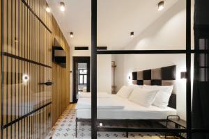 a bedroom with a white bed in a room at Main Square Rooms in Maribor