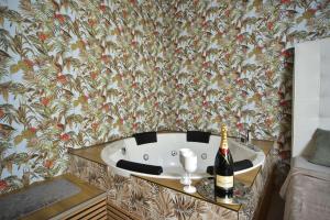 a bath tub with a bottle of wine on a table at TF Wellness in Prague +48 photos