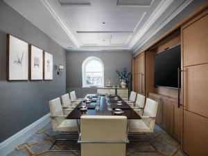 a conference room with a long table and chairs at The Langham London in London +37 photos