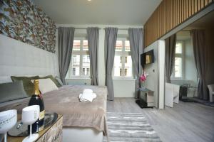 a bedroom with a bed with a bottle of wine on it at TF Wellness in Prague